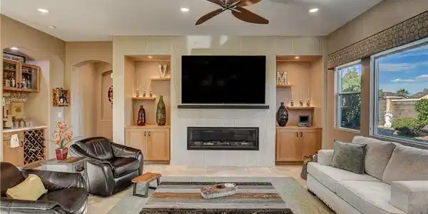 Image 2: A refined living space features a cozy fireplace,