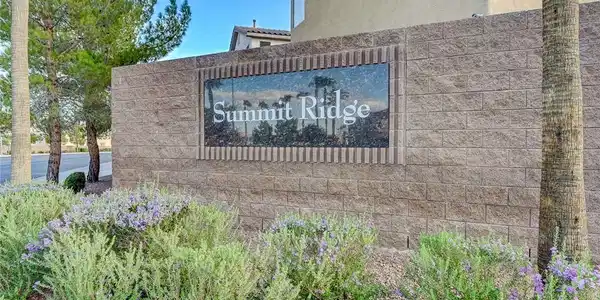 Image 3: A stone monument sign marks the entrance to the de