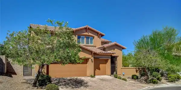 Image 2: Spanish tile roofing and a paved driveway enhance