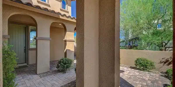 Image 4: Arched entryways and warm stucco columns frame a b