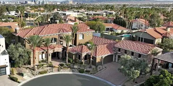 Image 2: Aerial view of residential area featuring a mounta