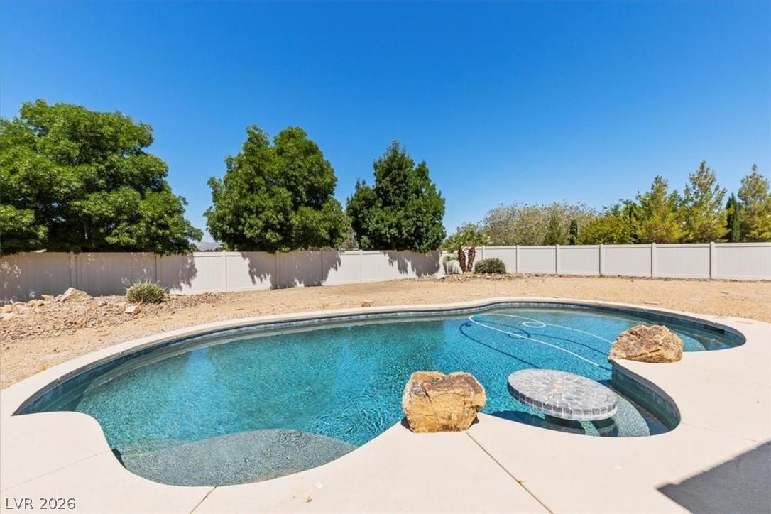 Image 2: This outdoor oasis features a beautiful pool, perf