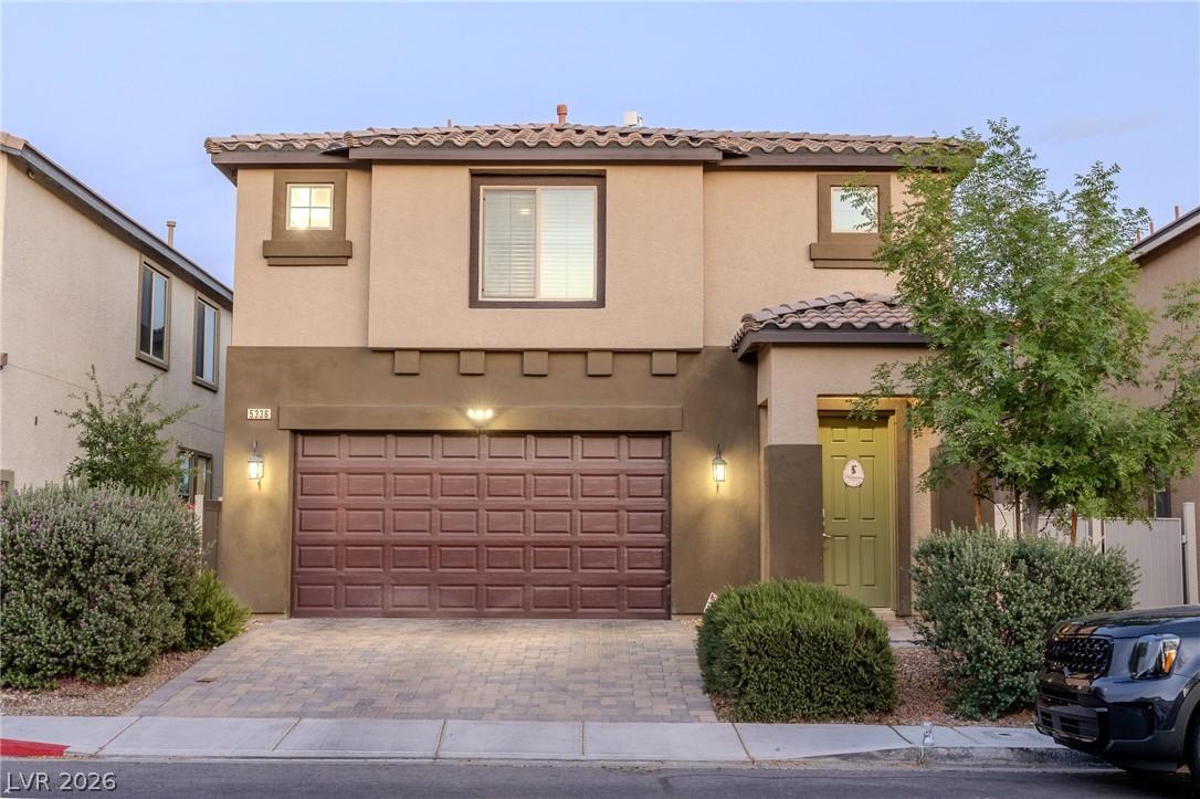 Image 1: This charming home offers a spacious garage and an