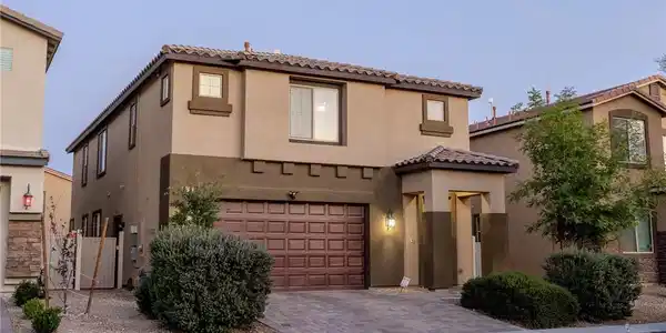 Image 2: This modern home features a charming exterior with