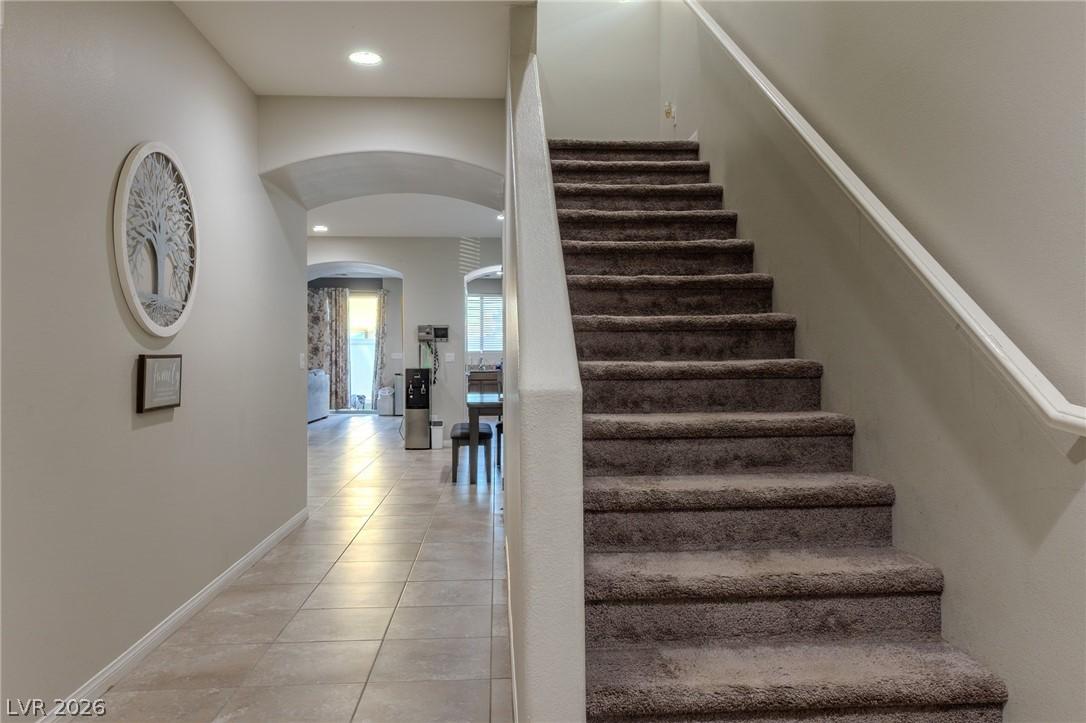 Image 3: This inviting hallway features a grand staircase a