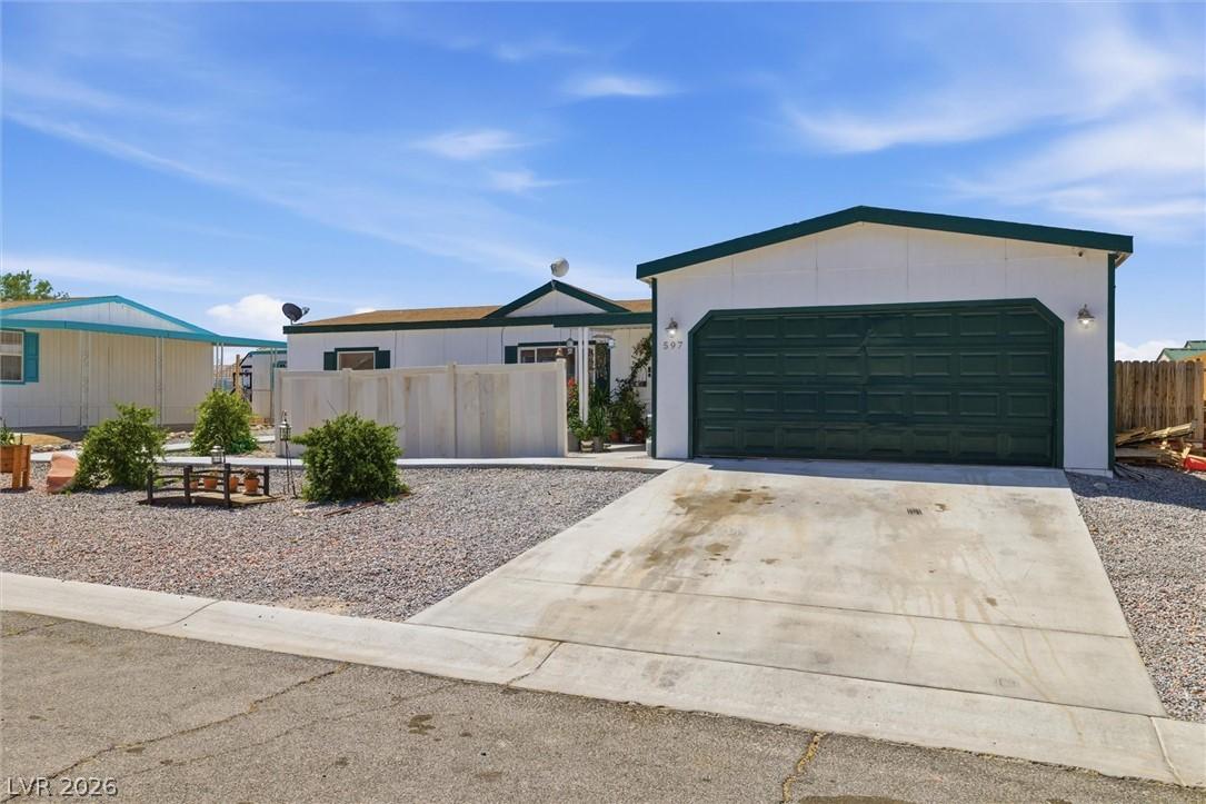 Image 2: A modest residence features a detached garage and