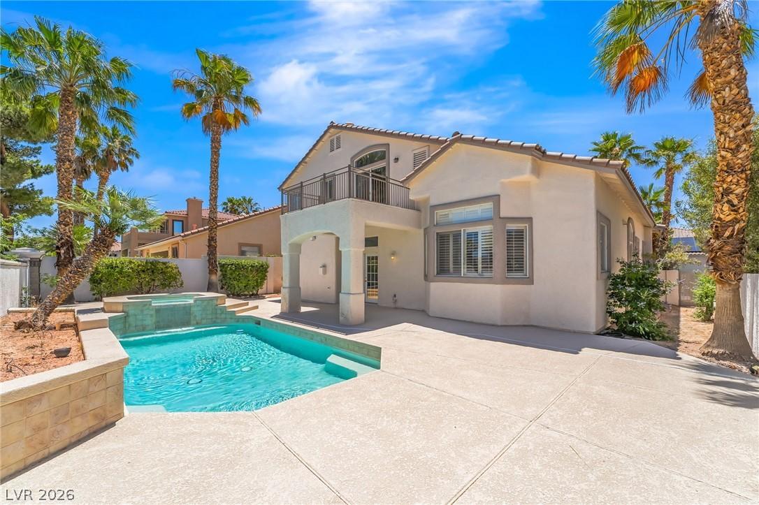 Image 1: An inviting backyard oasis awaits with a sparkling