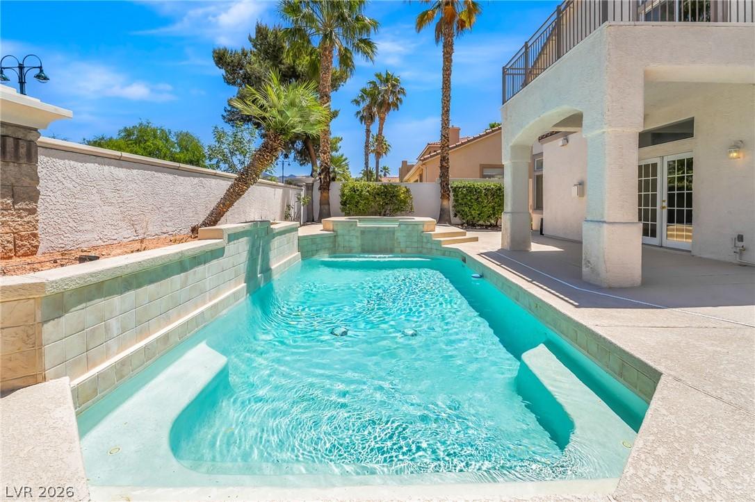 Image 3: An inviting backyard oasis offers a sparkling in-g