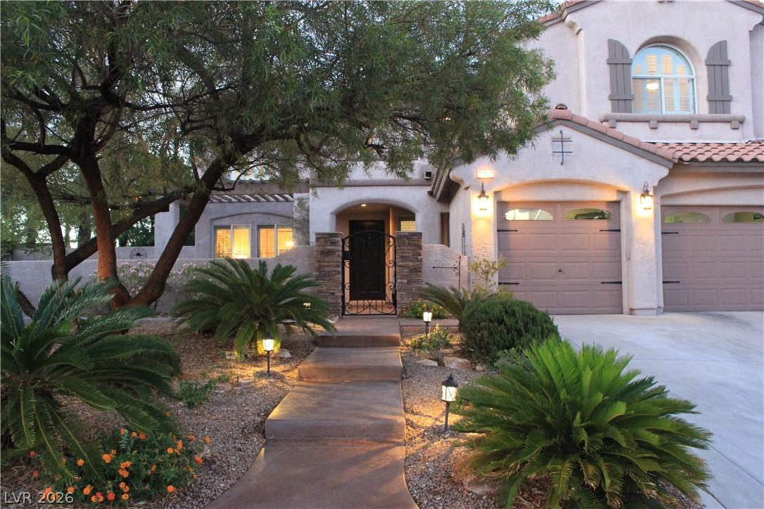 Image 3: A welcoming entry path leads to a home adorned wit