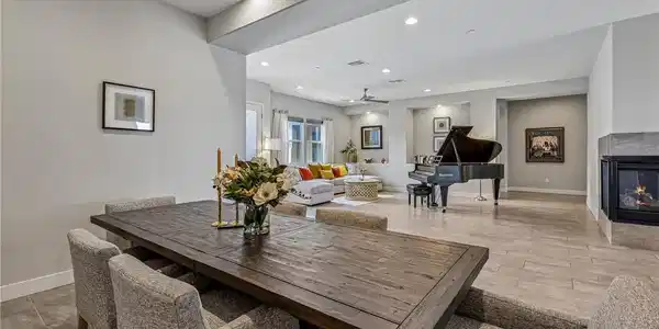 Image 4: A grand piano takes center stage in this spacious,