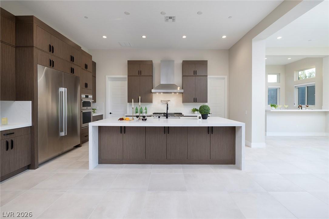 Image 3: Sleek, open-concept kitchen features dark wood cab