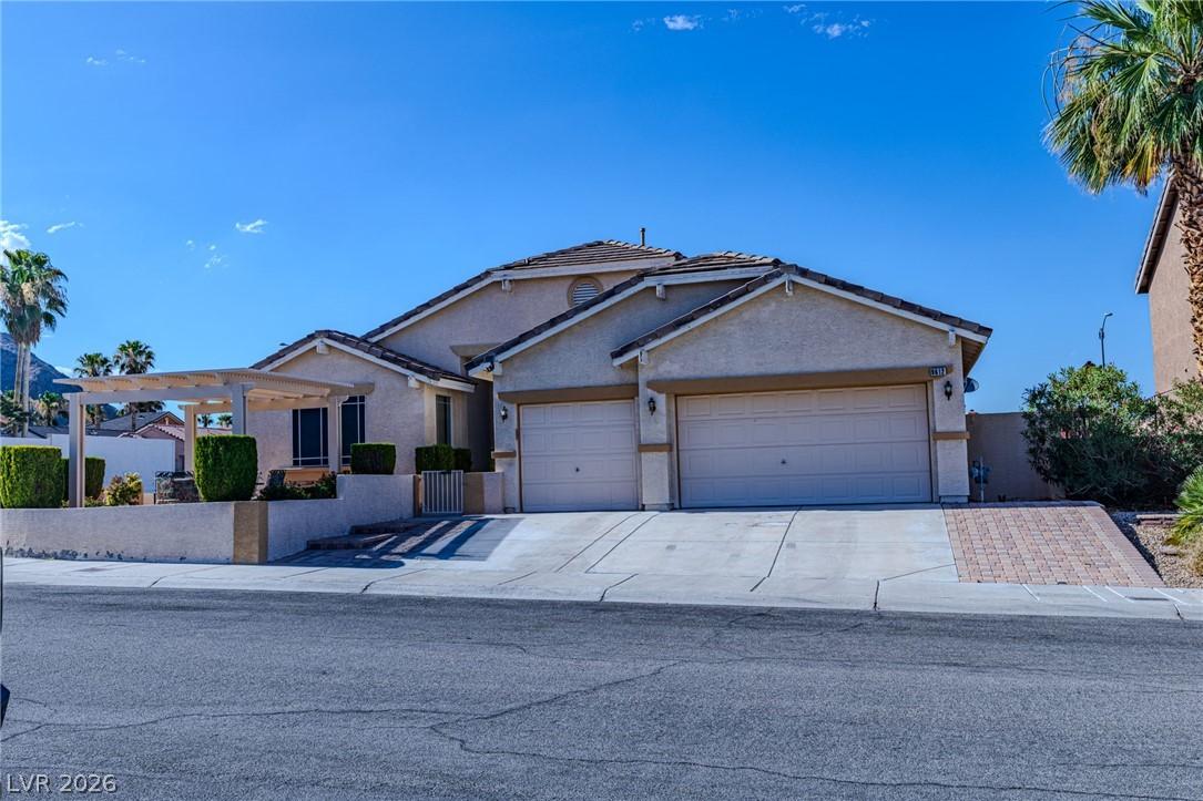 Image 1: A well-maintained stucco residence features an att