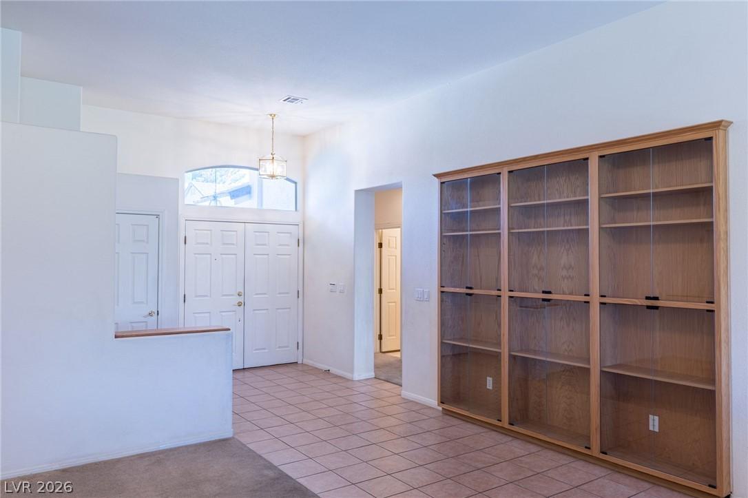 Image 3: A well-lit entry hall with ample natural light fro