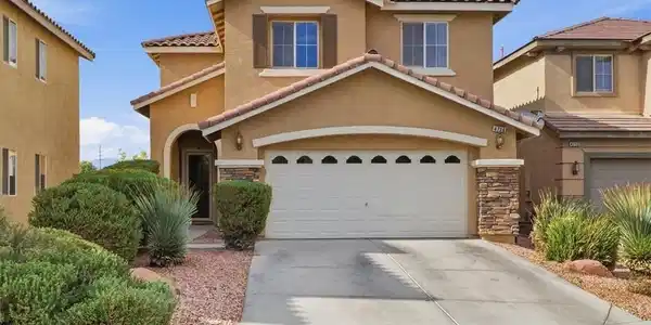 Image 2: An inviting arched entryway leads to a welcoming f