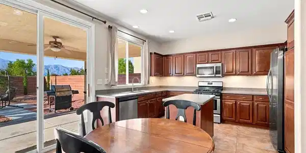 Image 4: An inviting open-concept layout showcases a kitche