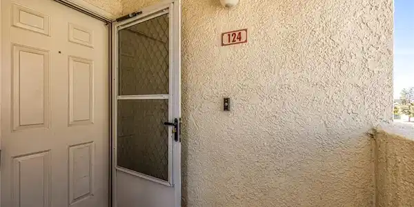 Image 4: View of exterior entry featuring stucco siding