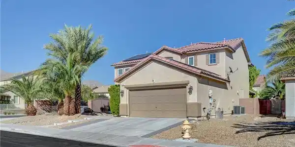 Image 2: Stately palm trees frame the concrete driveway lea