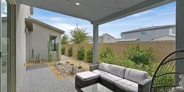Image 3: An inviting covered patio features neat block pave