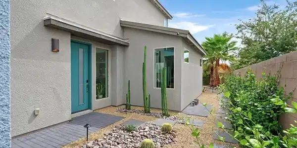 Image 4: Desert landscaping and stone pathways create an in