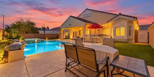 Image 2: A sparkling swimming pool highlights this backyard