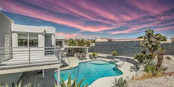 Image 3: View of swimming pool with a patio area and a fenc