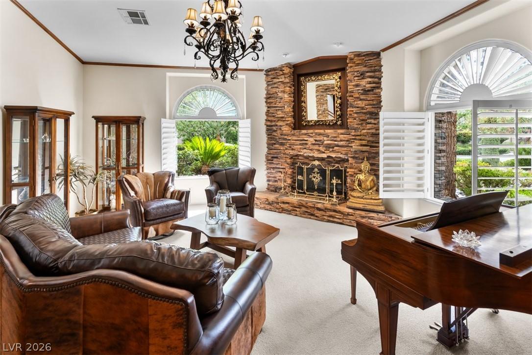 Image 2: Grand living room features a stone fireplace, arch