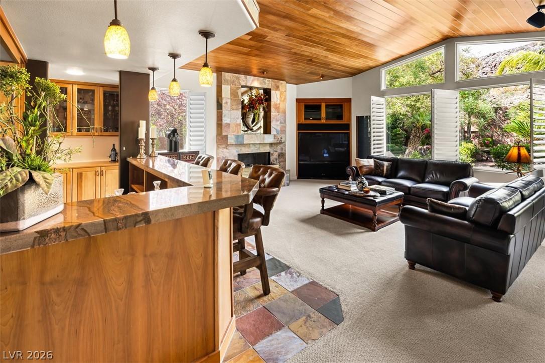 Image 4: A striking stone fireplace and wet bar complement