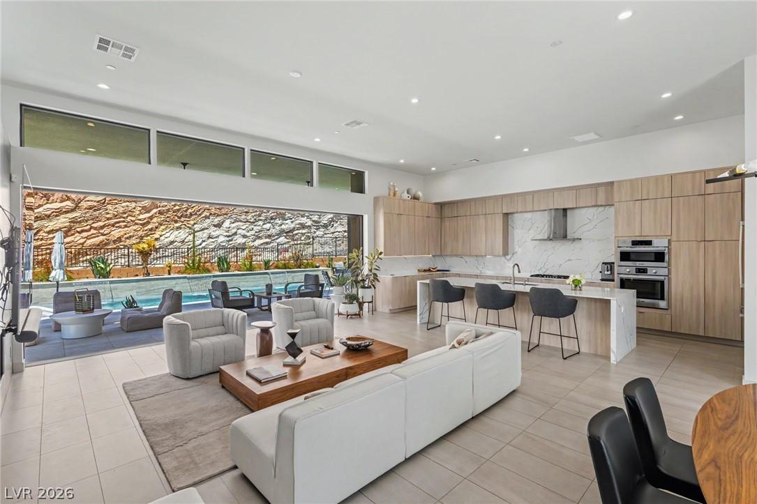 Image 3: An open-concept living space with a gourmet kitche