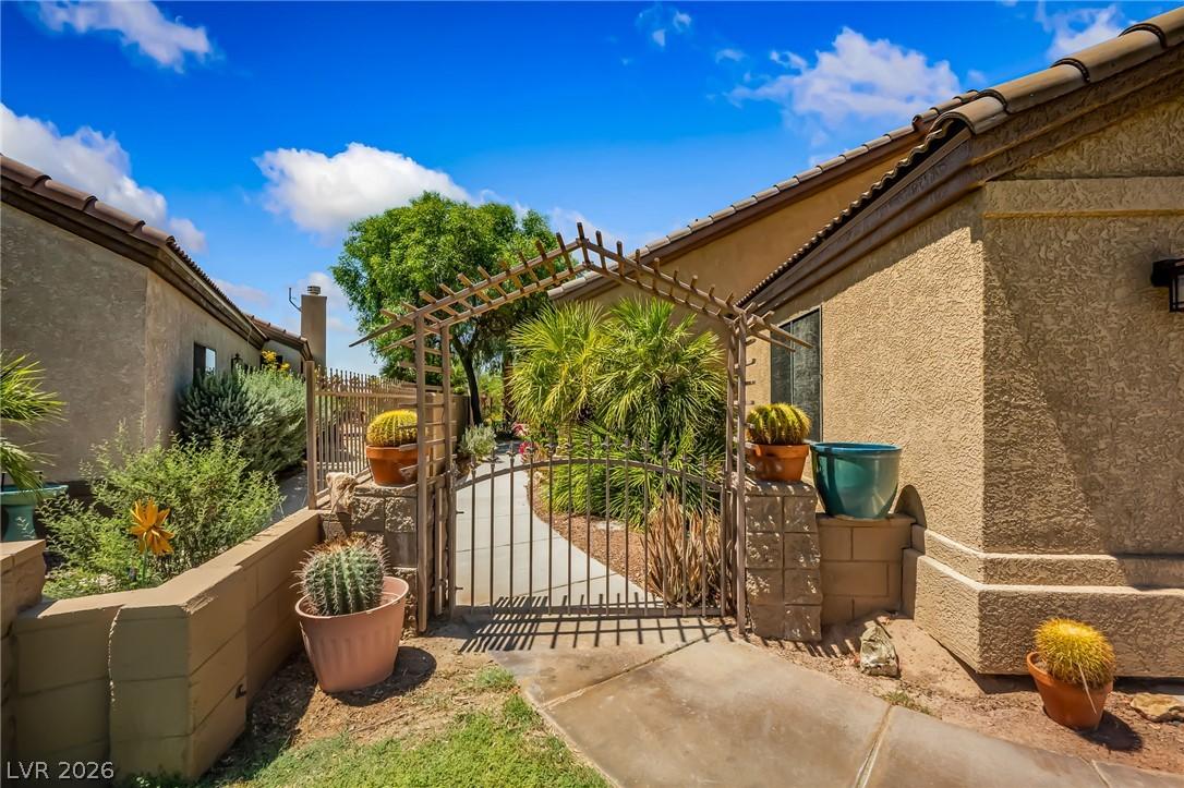 Image 2: Enter through the charming gated arbor into a dese