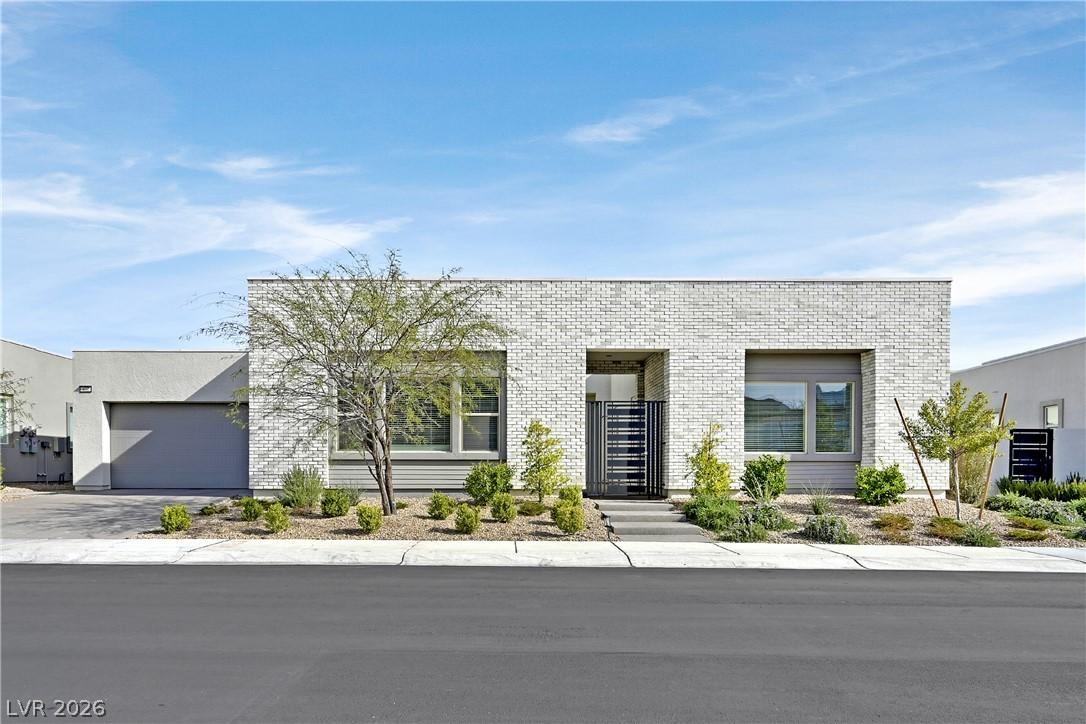 Image 2: Modern facade with sleek brickwork, integrated gar