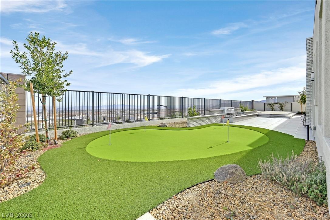 Image 4: An inviting backyard features a private putting gr