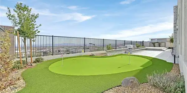 Image 4: An inviting backyard features a private putting gr