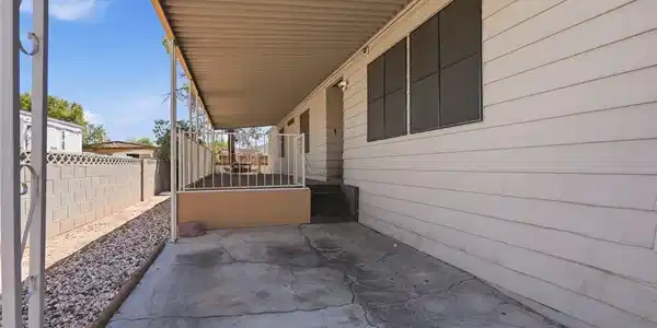 Image 4: A long covered patio provides shaded outdoor space