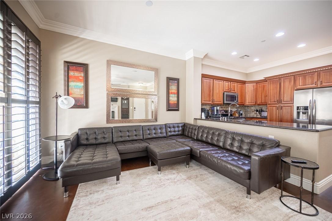 Image 3: Living room with crown molding, recessed lighting,