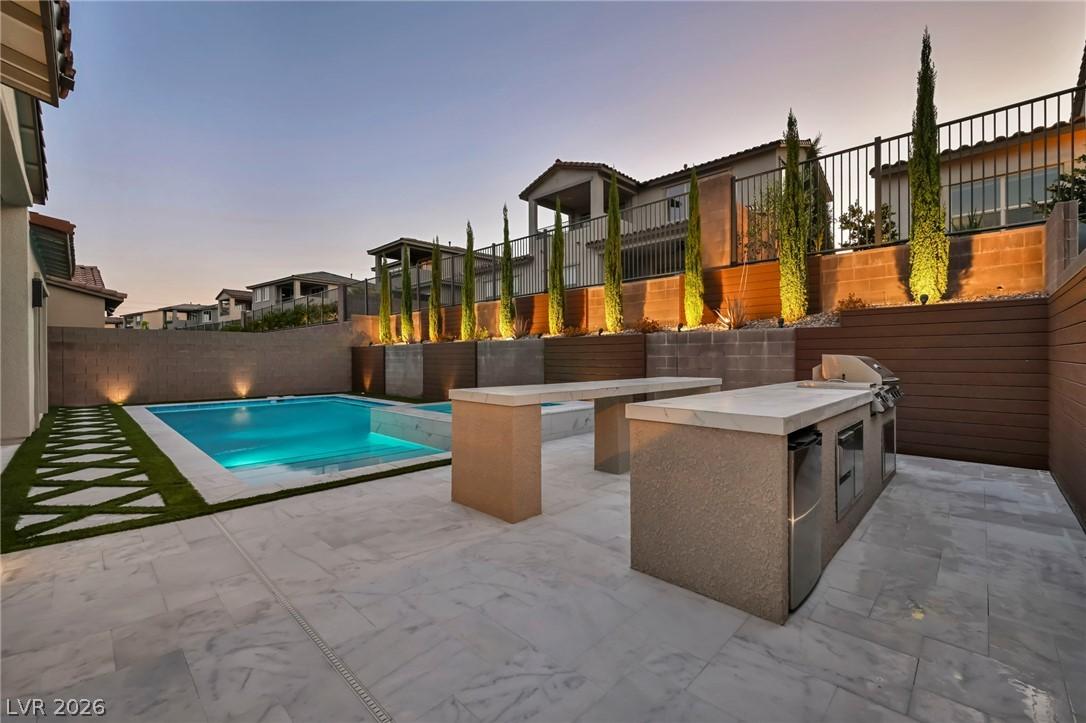 Image 2: An inviting backyard oasis with a pristine swimmin