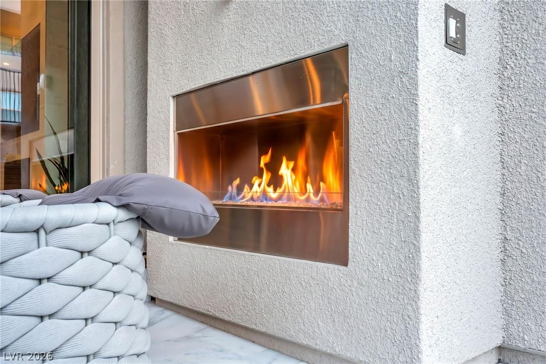 Image 3: An inviting outdoor fireplace provides warmth and