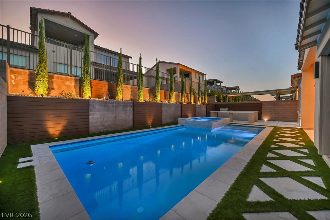 Image 4: An inviting backyard oasis offers a sparkling pool