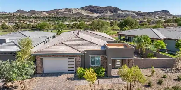 Image 2: A desert oasis with a paved driveway and a clear v