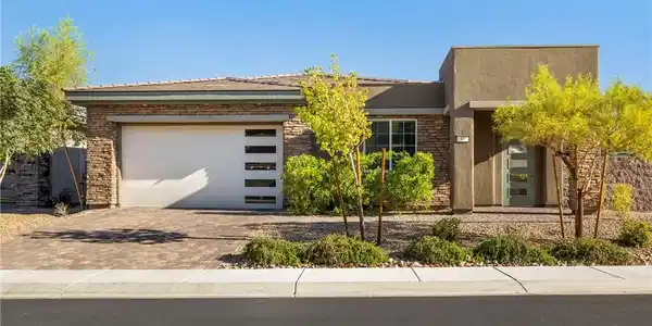 Image 3: A striking modern exterior features stone accents