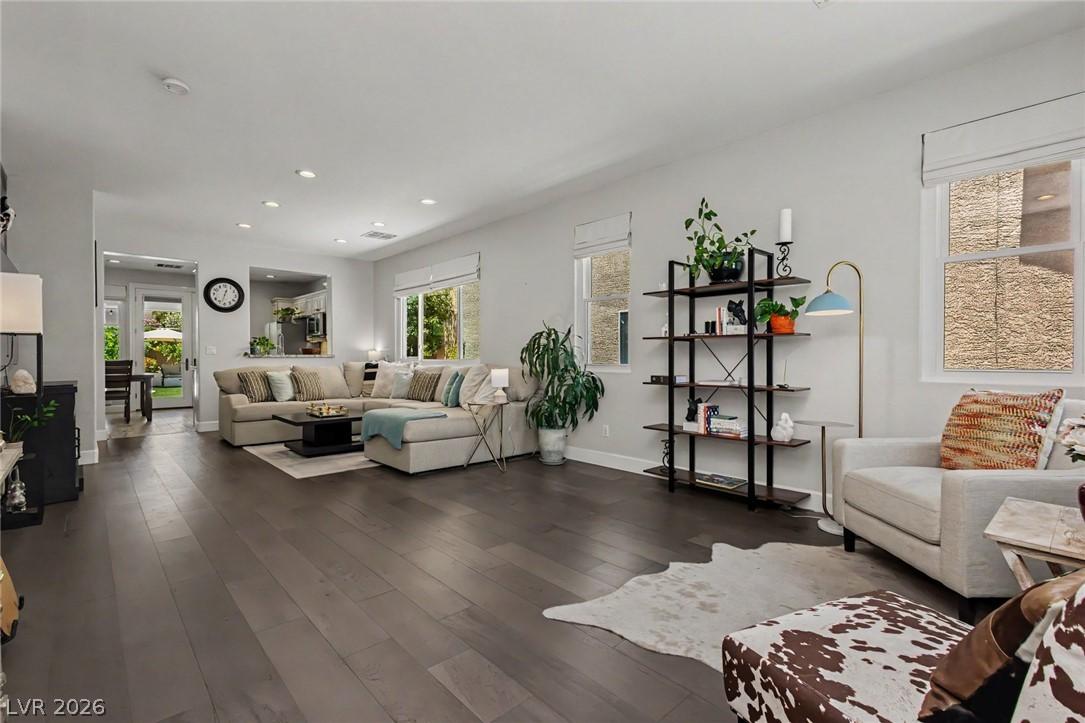 Image 4: Hardwood floors stretch across this inviting livin