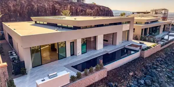 Image 2: Modern architecture cascades down a desert hillsid