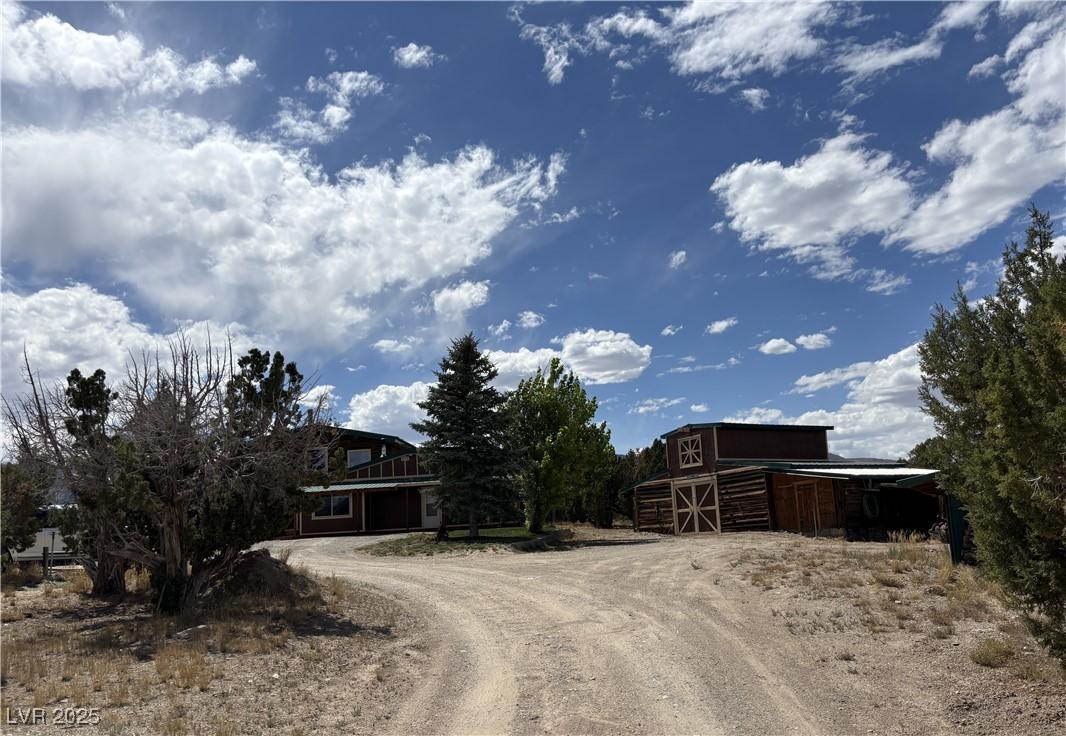 Image 1: View of dirt / gravel road with a barn