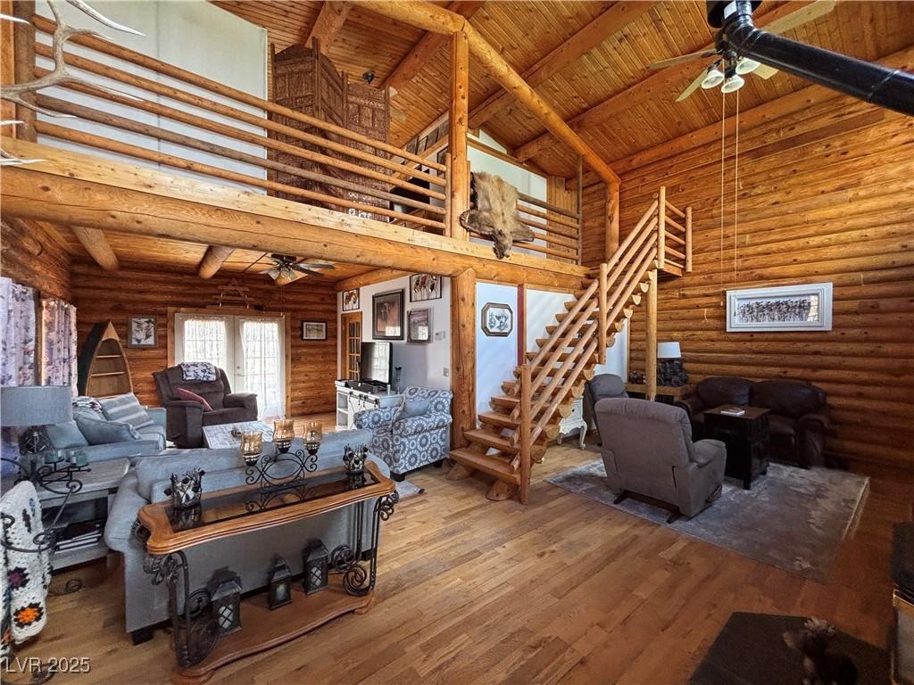 Image 4: Living room featuring ceiling fan, high vaulted ce