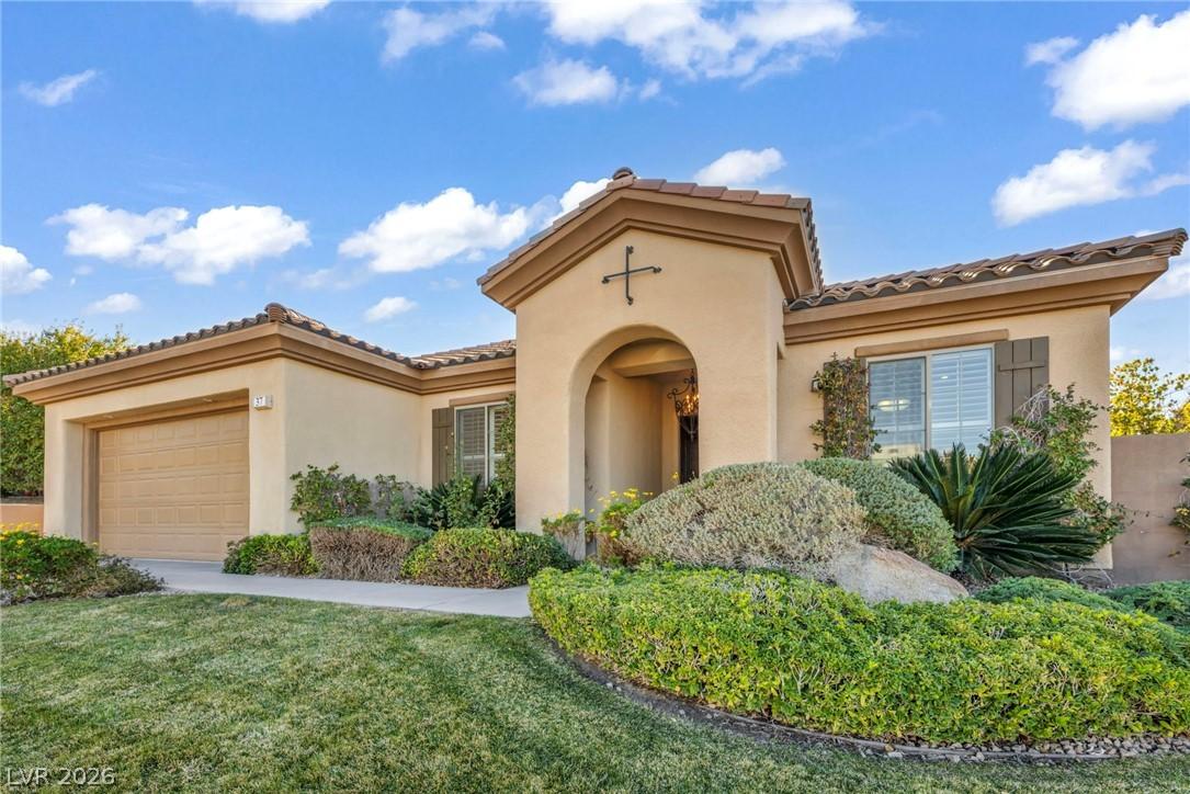 Image 3: Mediterranean / spanish home with a front yard, a