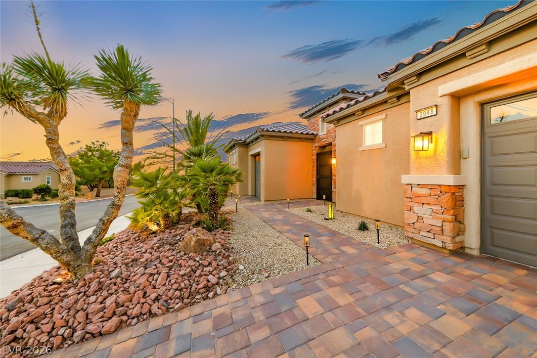 Image 3: A paver driveway and desert landscaping welcome yo