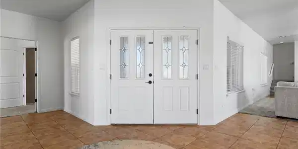 Image 4: A welcoming entry features decorative glass panel