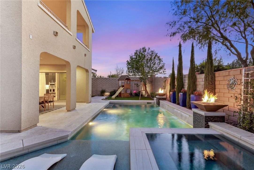Image 4: An inviting backyard oasis offers a sparkling pool