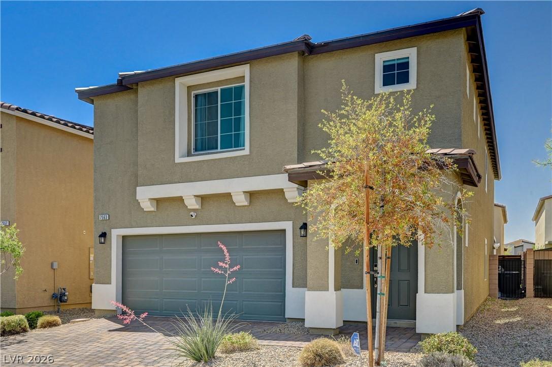Image 2: This contemporary residence boasts a stucco exteri