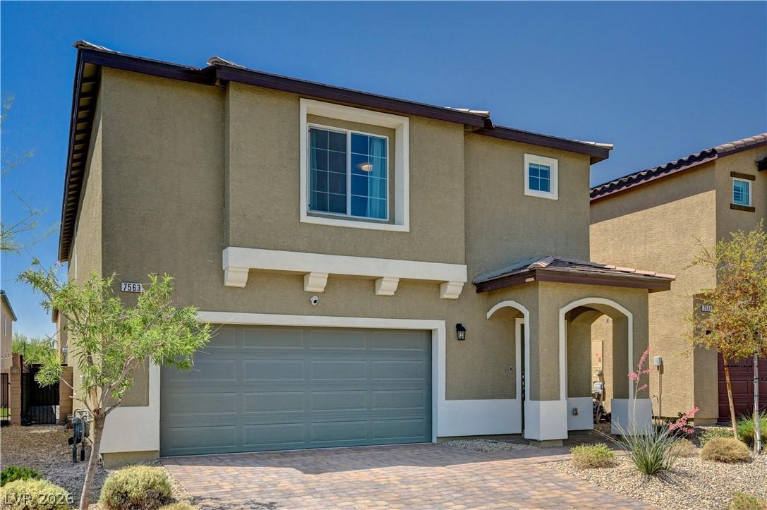 Image 3: This two-story residence features a charming arche