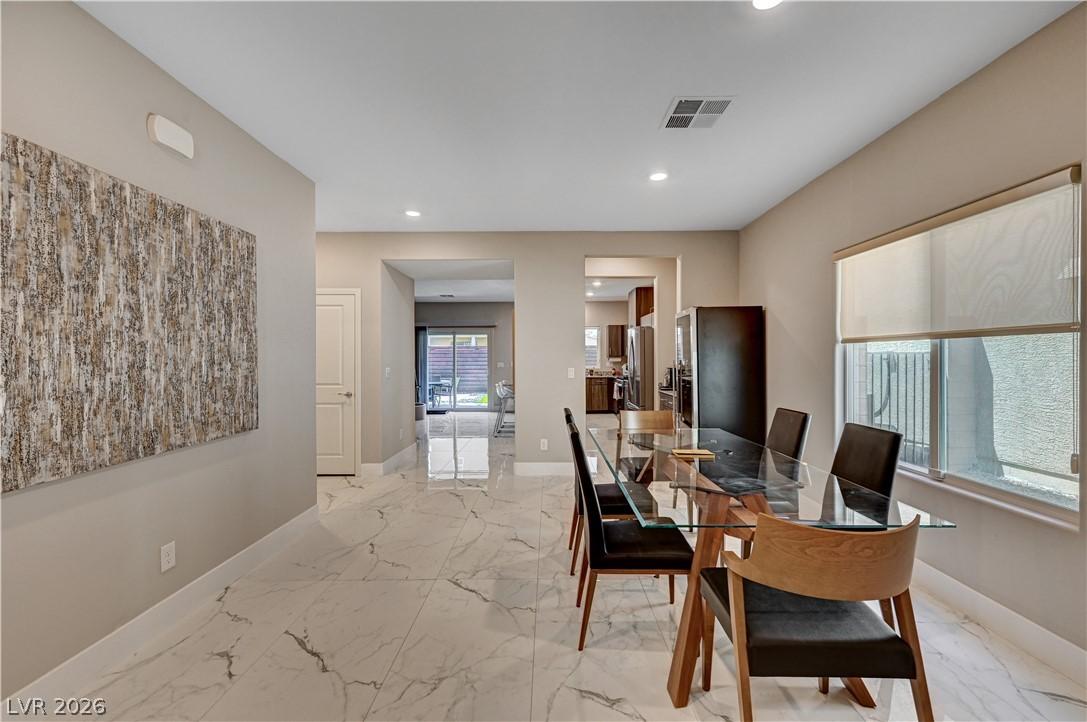 Image 4: This dining area features glossy floors and ample